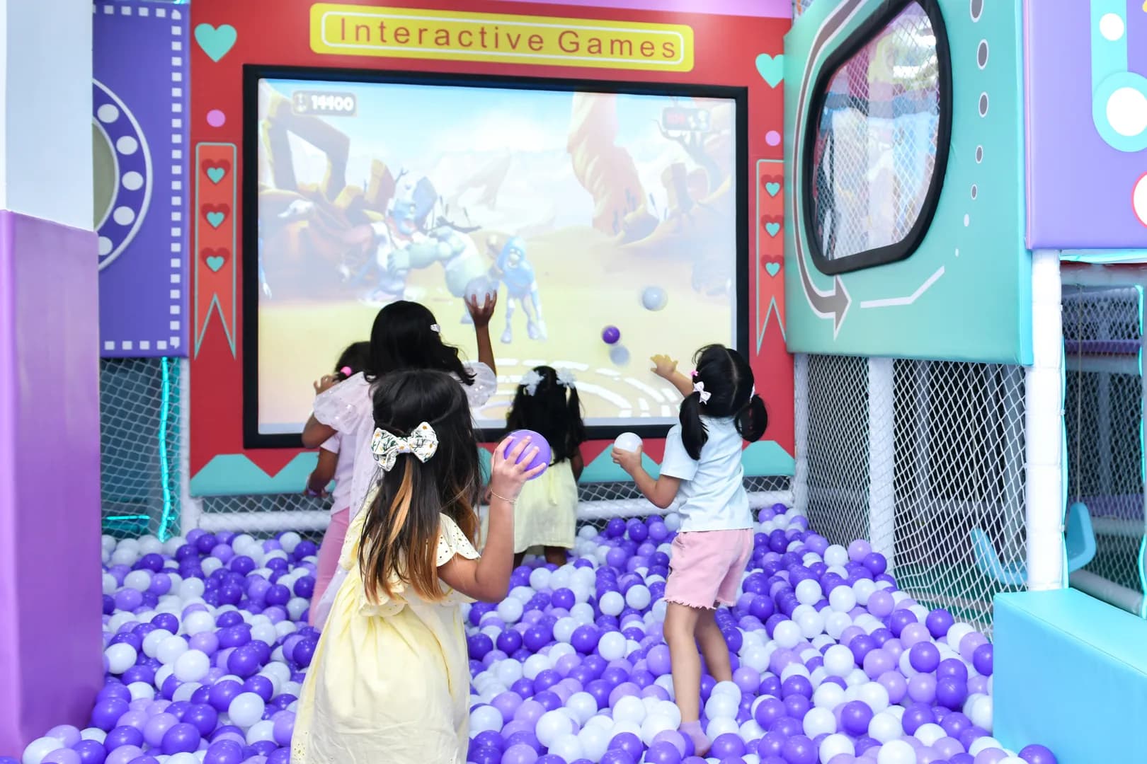Children playing in a colorful ball pit at Ooyoo Playcenter
