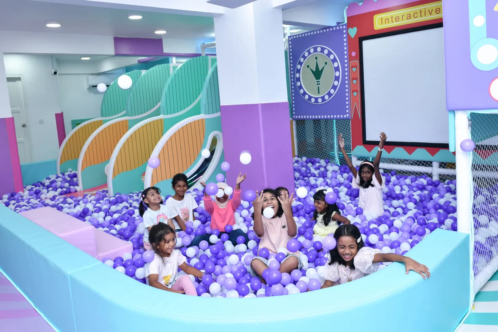 Children playing in a colorful ball pit at Ooyoo Playcenter
